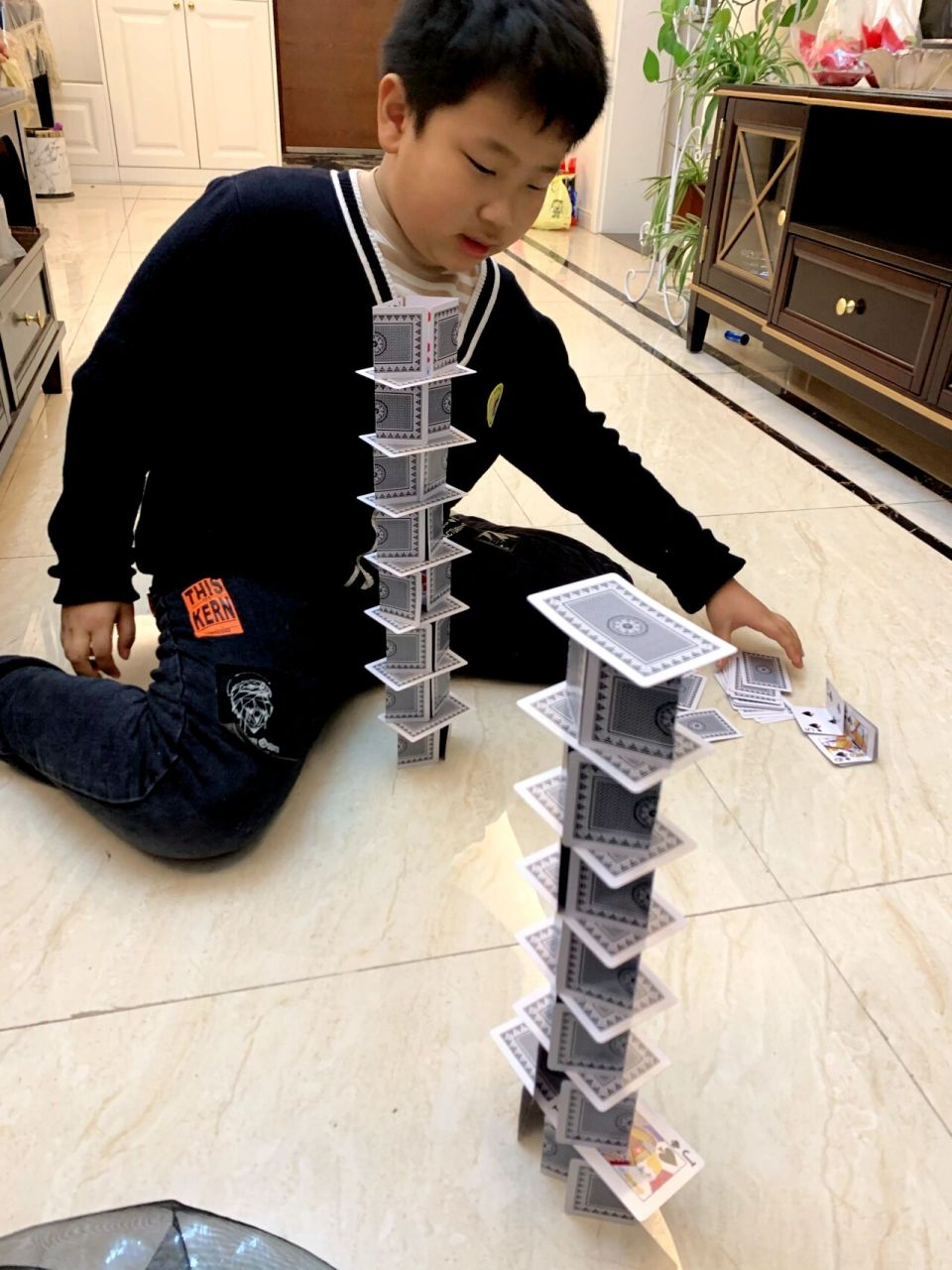 搭扑克塔大比拼 图一:我们来比赛吧! 图二:倒了,再来一个和妈妈比!