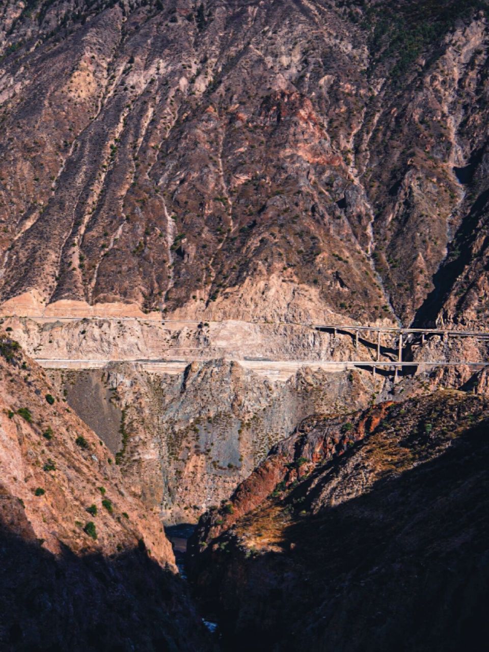 一边是稀石碎块落叶铺就的小路,一边是湍急的峡谷溪流.