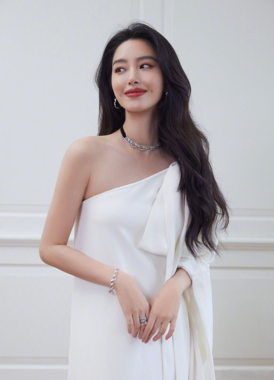 杨采钰 身着白色斜肩裙装亮相展览开幕红毯,搭配慵懒卷发明艳动人