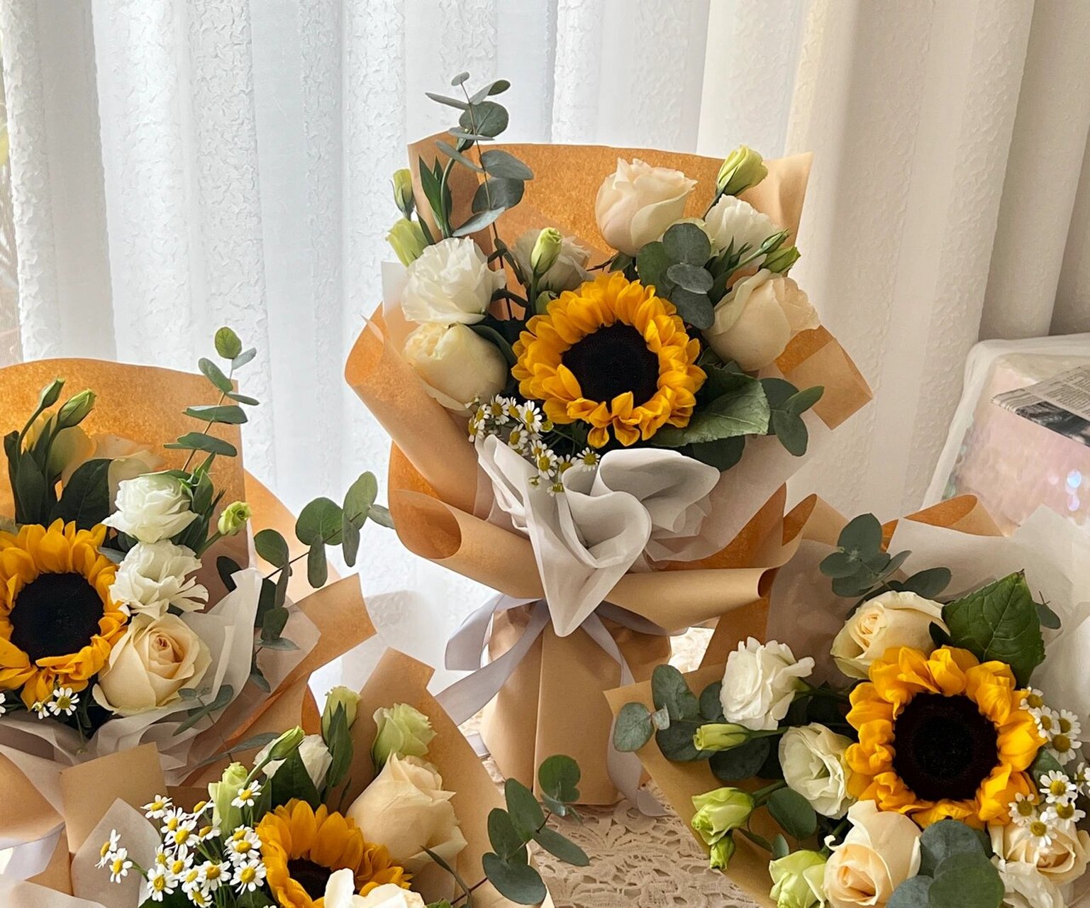 向日葵小花束 向日葵主花搭配了香槟玫瑰,洋甘菊,绿色和白色洋桔梗