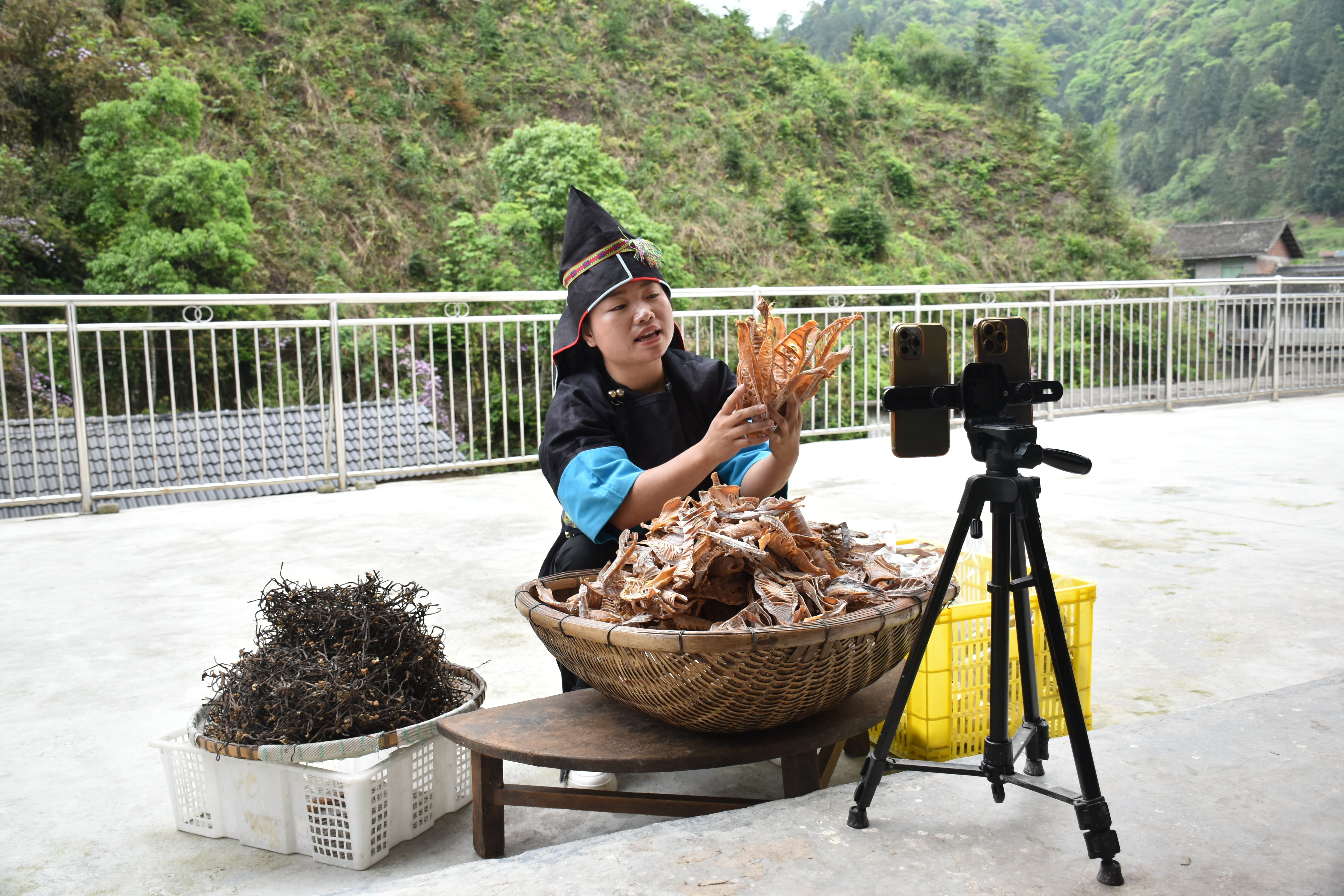 里,王启红在院坝里支起手机,一根板凳摆上刚做好的笋干,以大山为背景