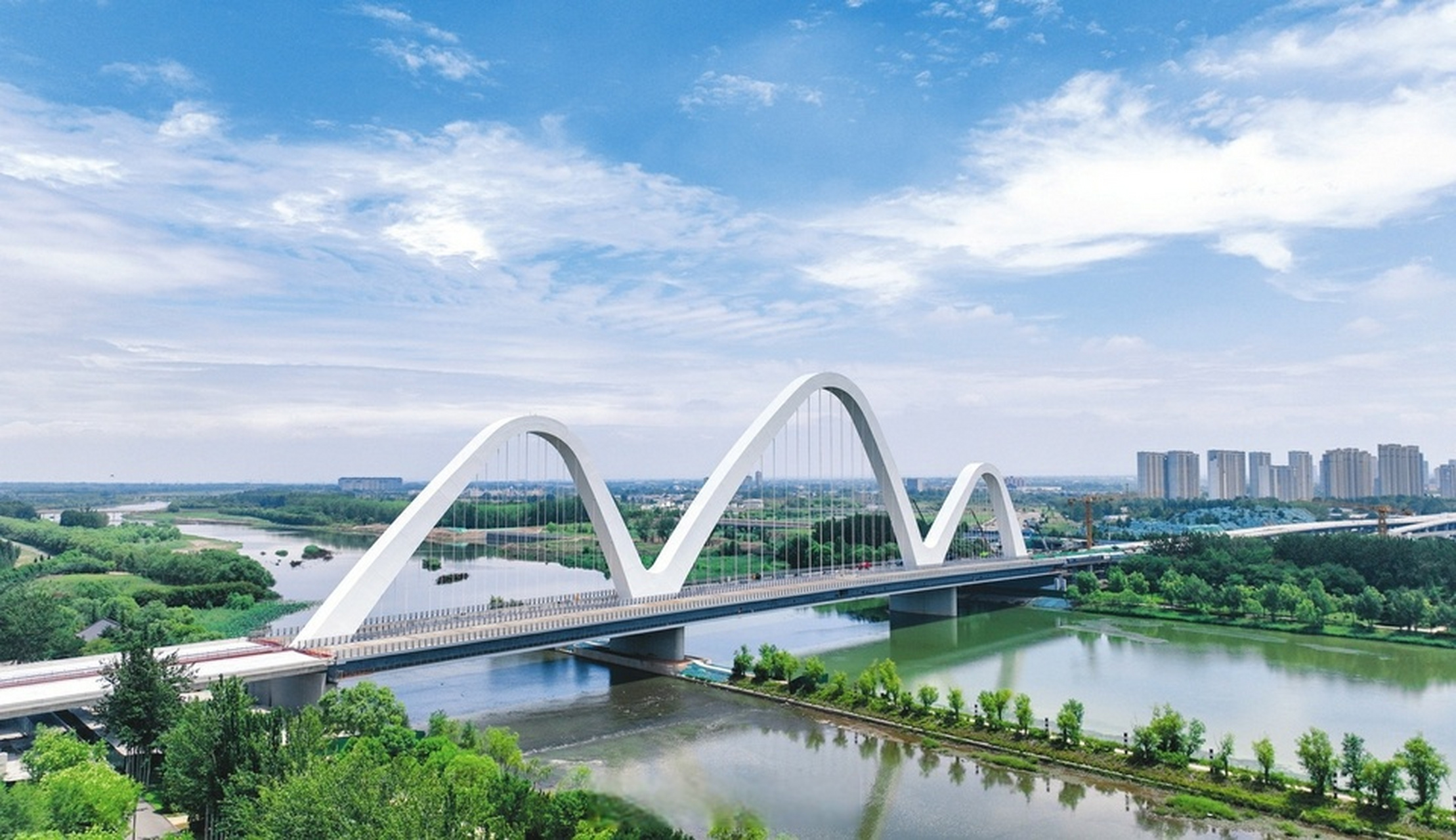 临汾市河汾一路跨汾河大桥工程项目涂装作业完成,桥体在蓝天白云的