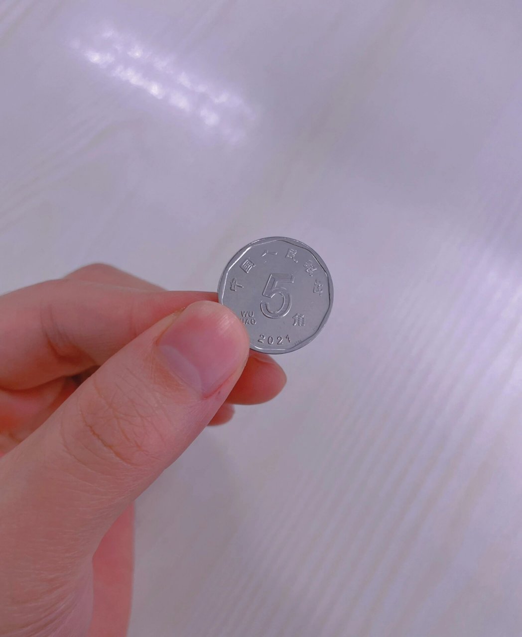 新版的5毛硬币 新版的五毛硬币跟之前的一毛好像呀 感觉还是以前的
