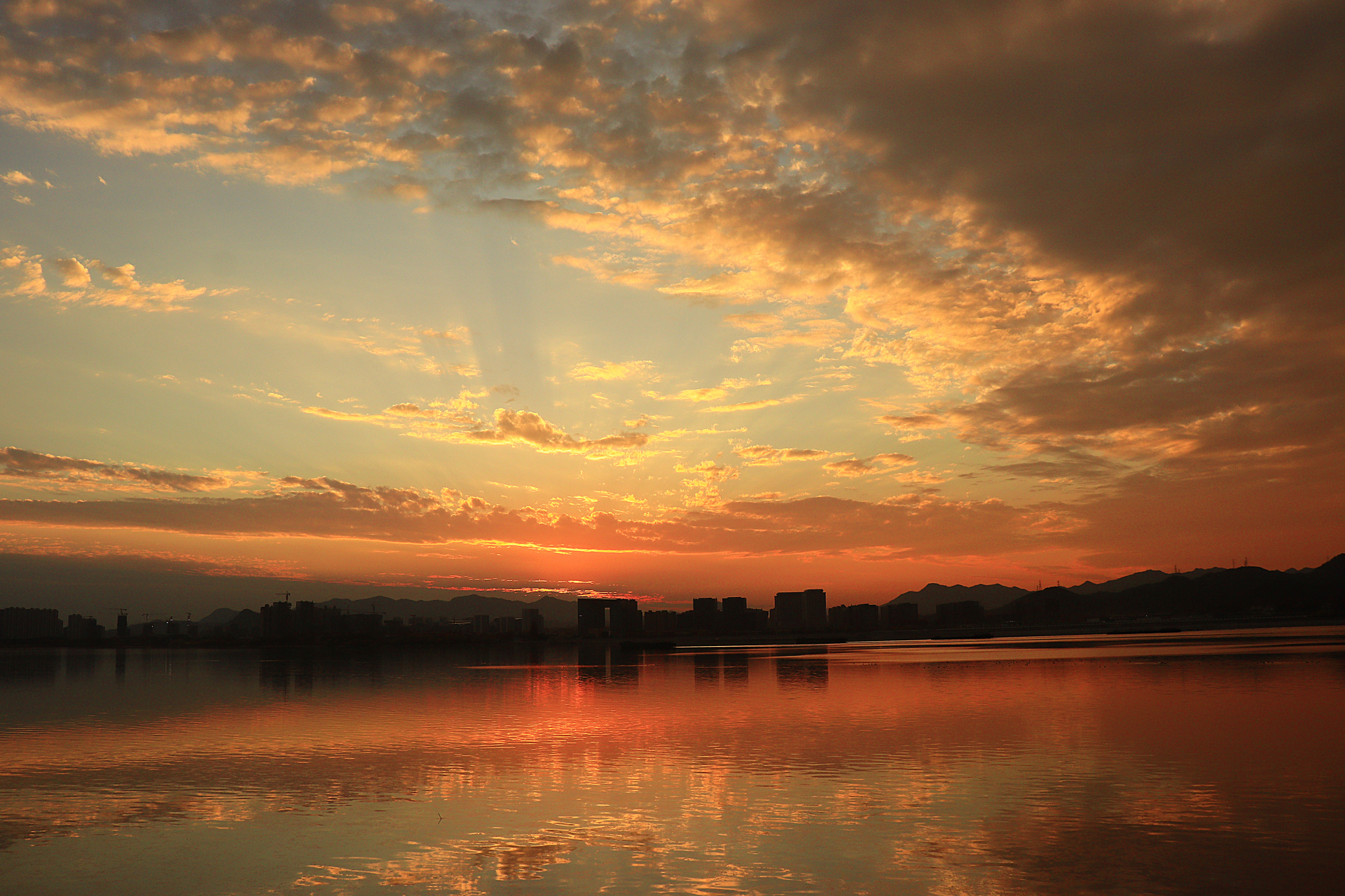 今天傍晚在柔和的阳光和漂亮的云彩下,湖面荡起涟漪,波光粼粼,倒影着