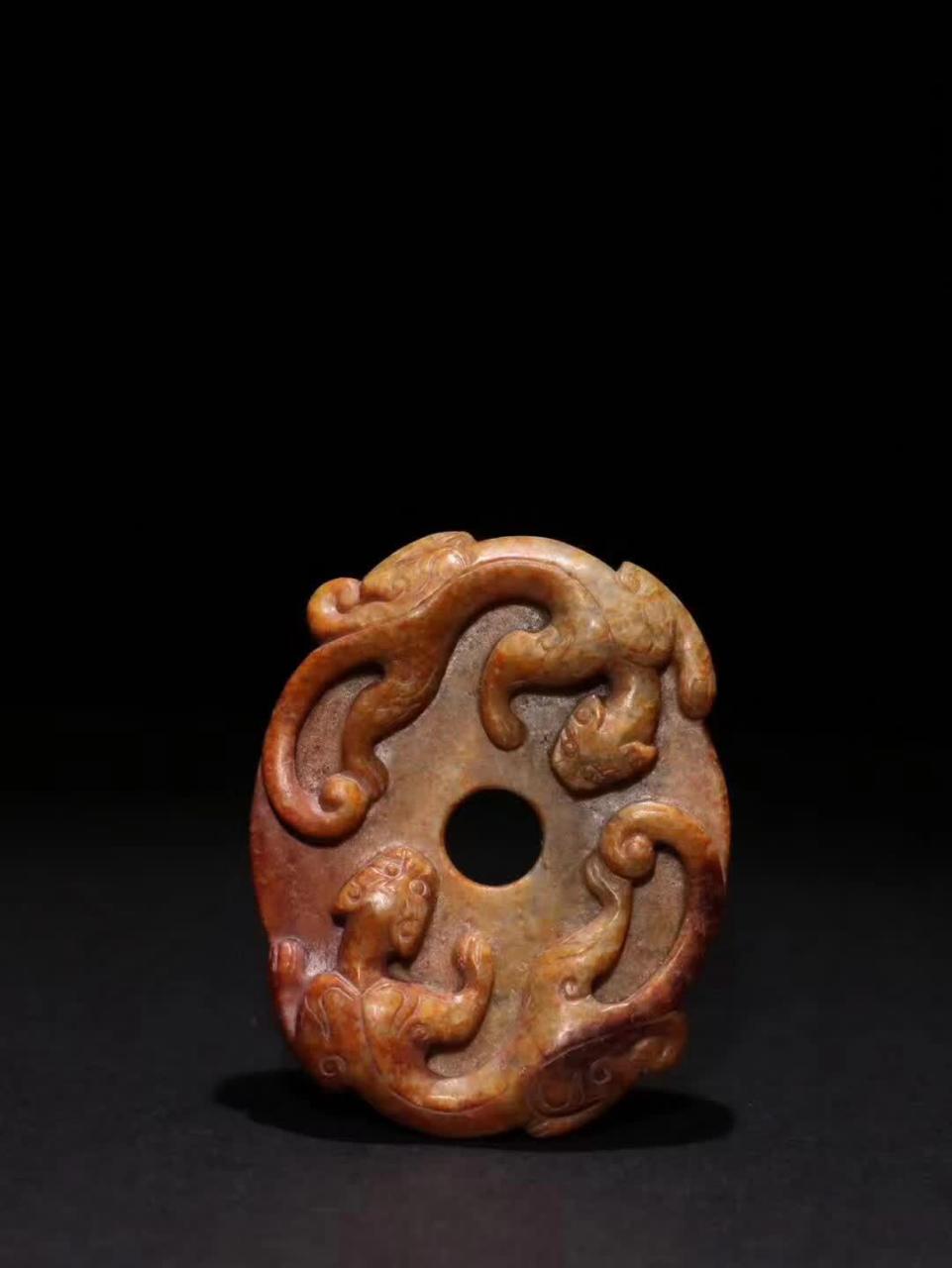自明代的和田黄玉《双螭龙》玉璧,规格精巧,宽度为6.6cm,高度为5.