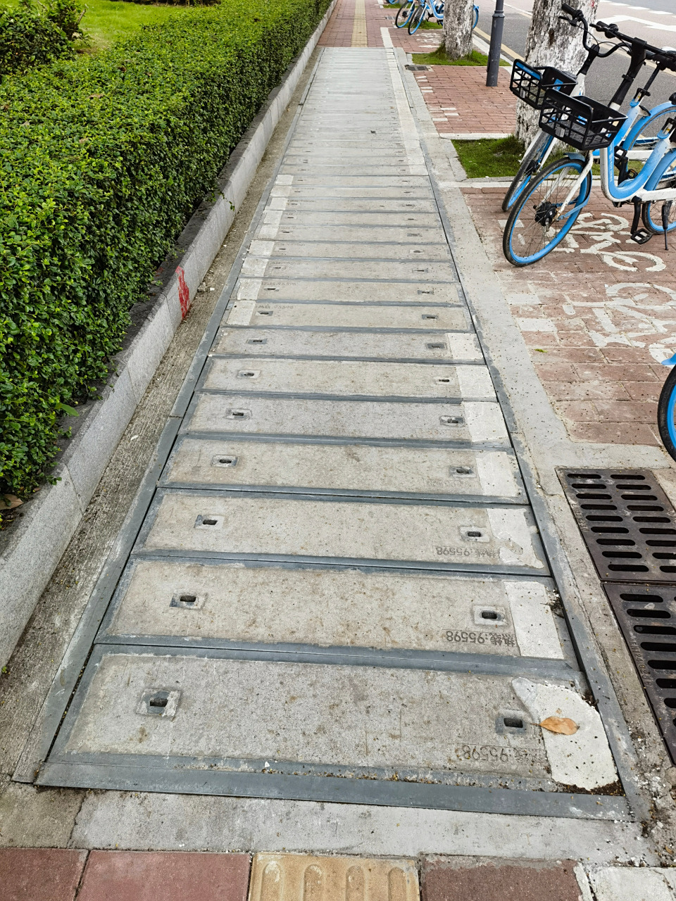 走在人行道,发现好多经过盲道的电缆沟盖板都补做了盲道,有一处更长的