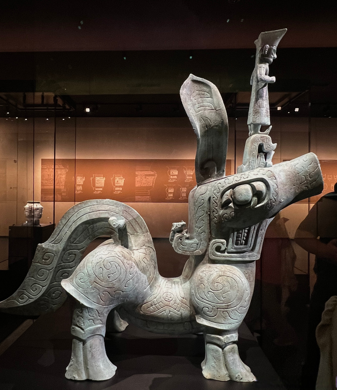 还有这个三星堆青铜神兽,脑门上站着一个人,有一说一,他的这一身打扮