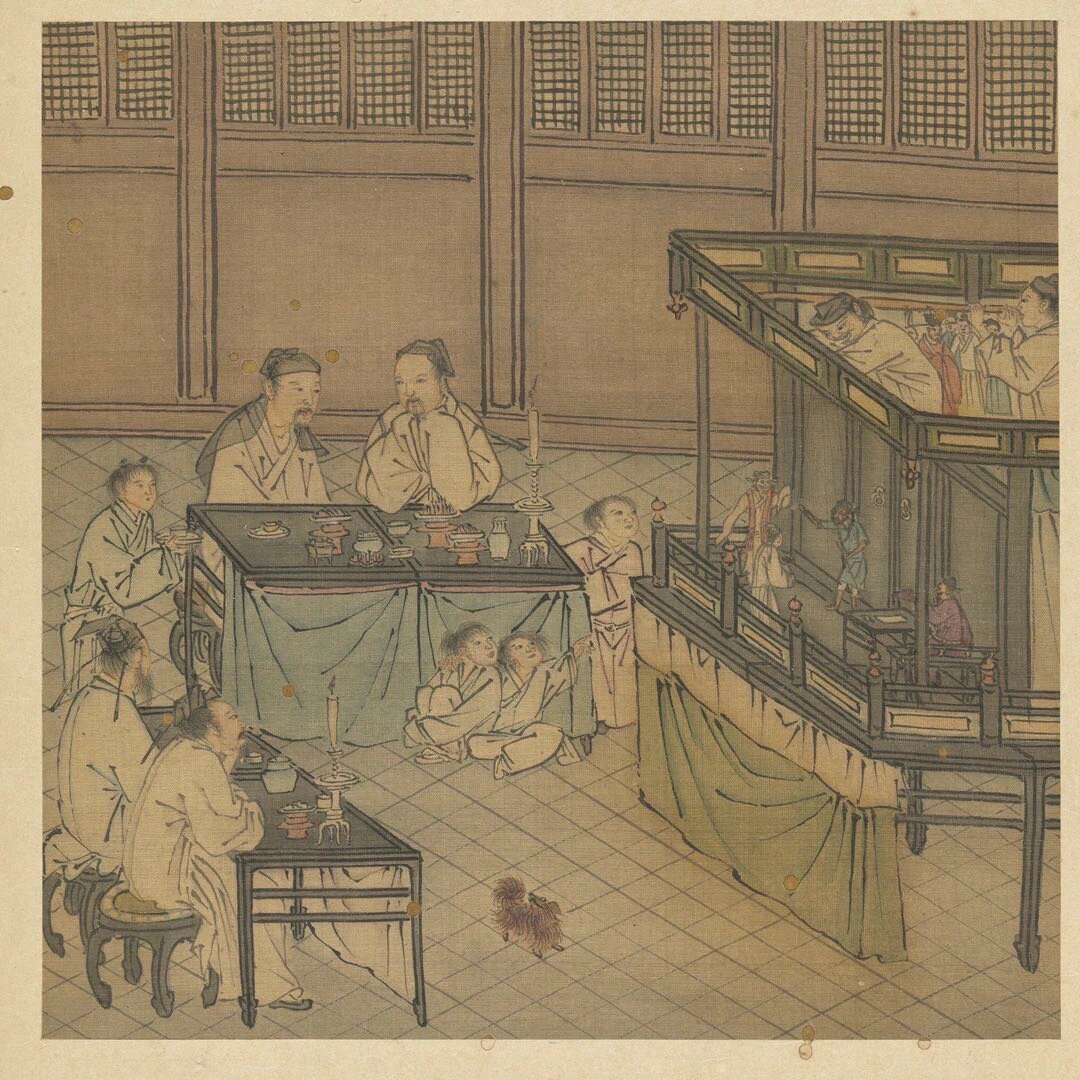 图1中所绘为室内的宴会,宴会中有傀儡戏表演,戏台搭在长桌拼成的高台