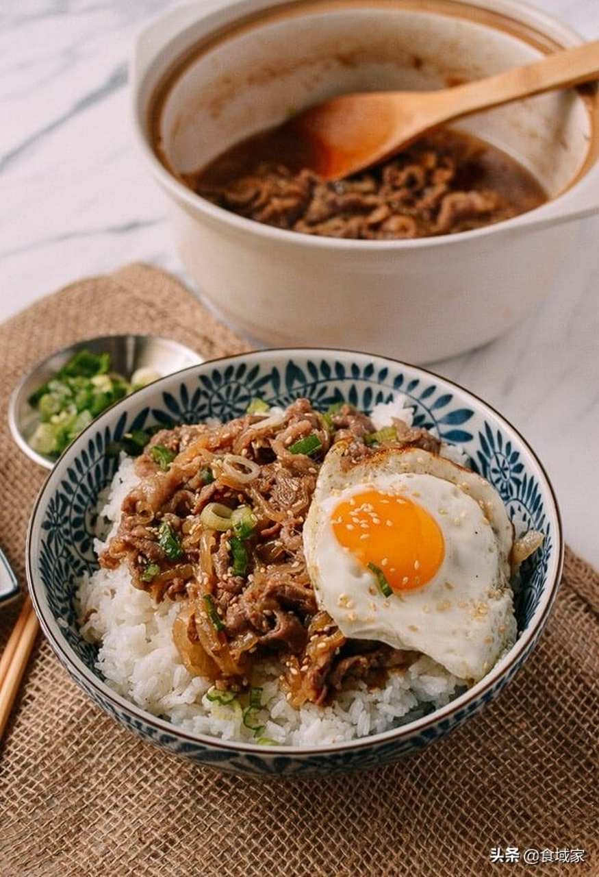 日式肥牛饭,又称为"寿喜烧饭"或"牛肉饭",是日本料理中的一种经典美食