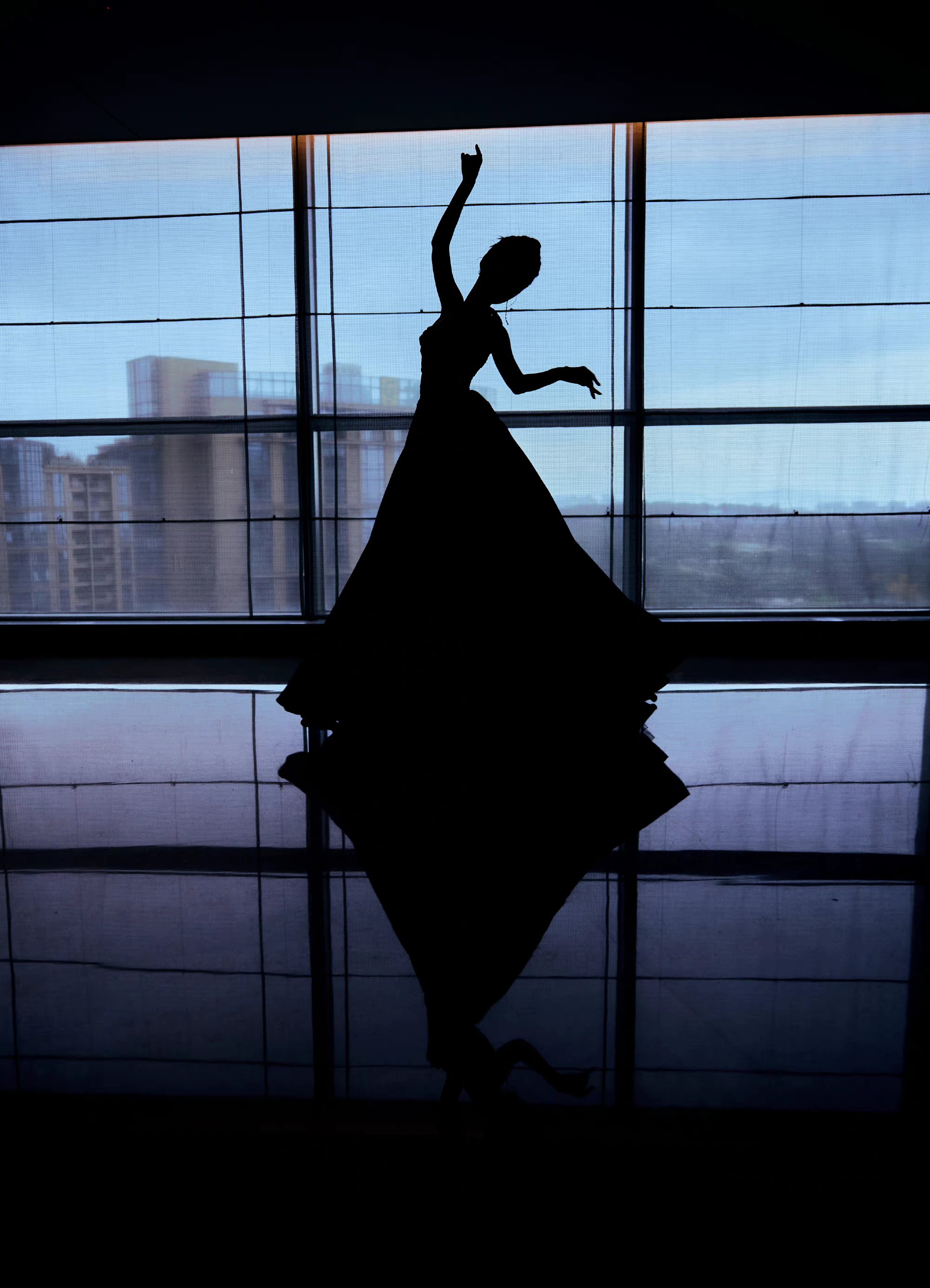 以纯黑色颜色为主的连衣裙,修身上半身和夸张感的裙摆之间形成了侗热