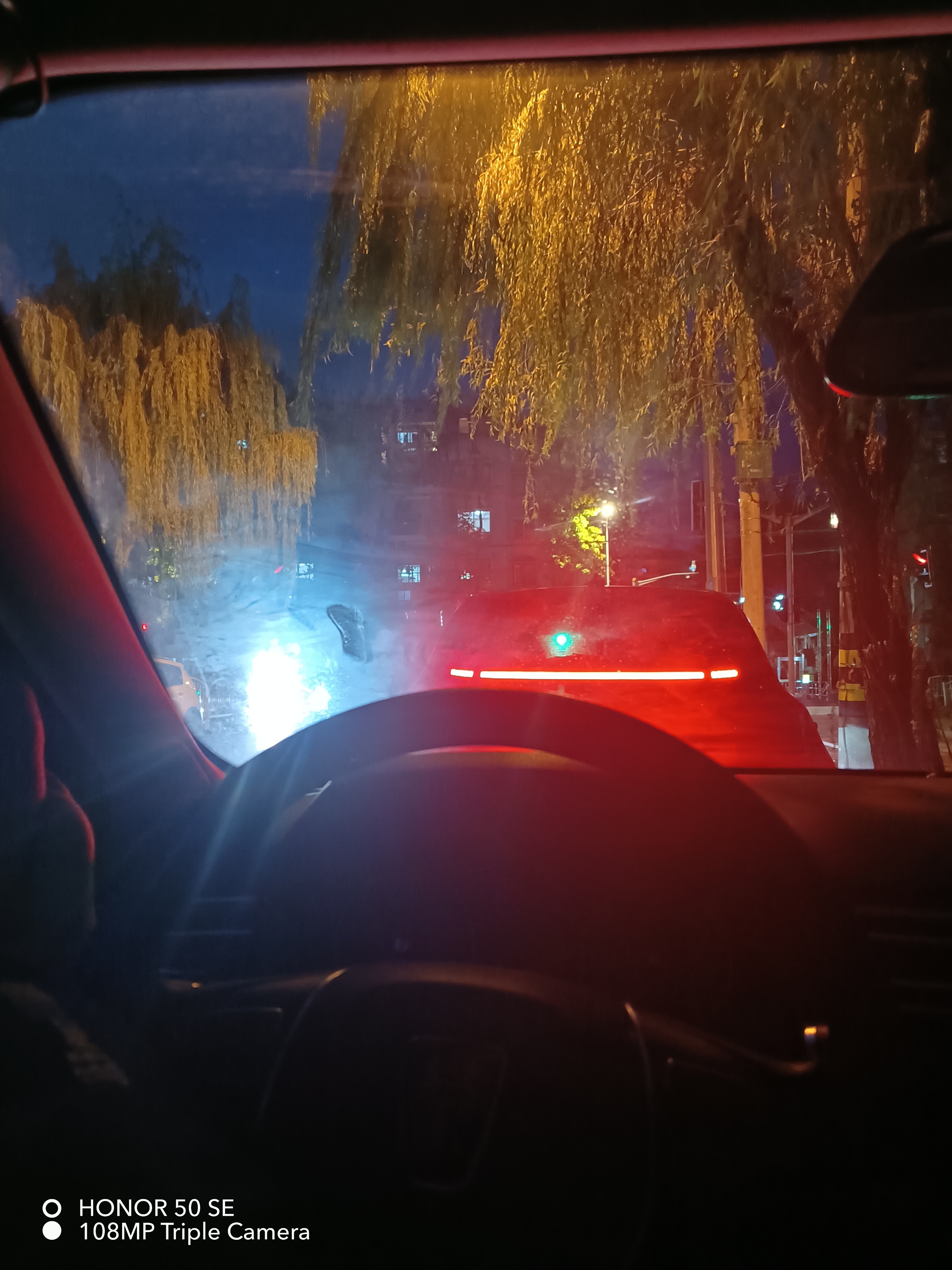 在夜色的深邃中,一辆黑色汽车静谧地停在路边,车窗半开,仿佛在邀请人