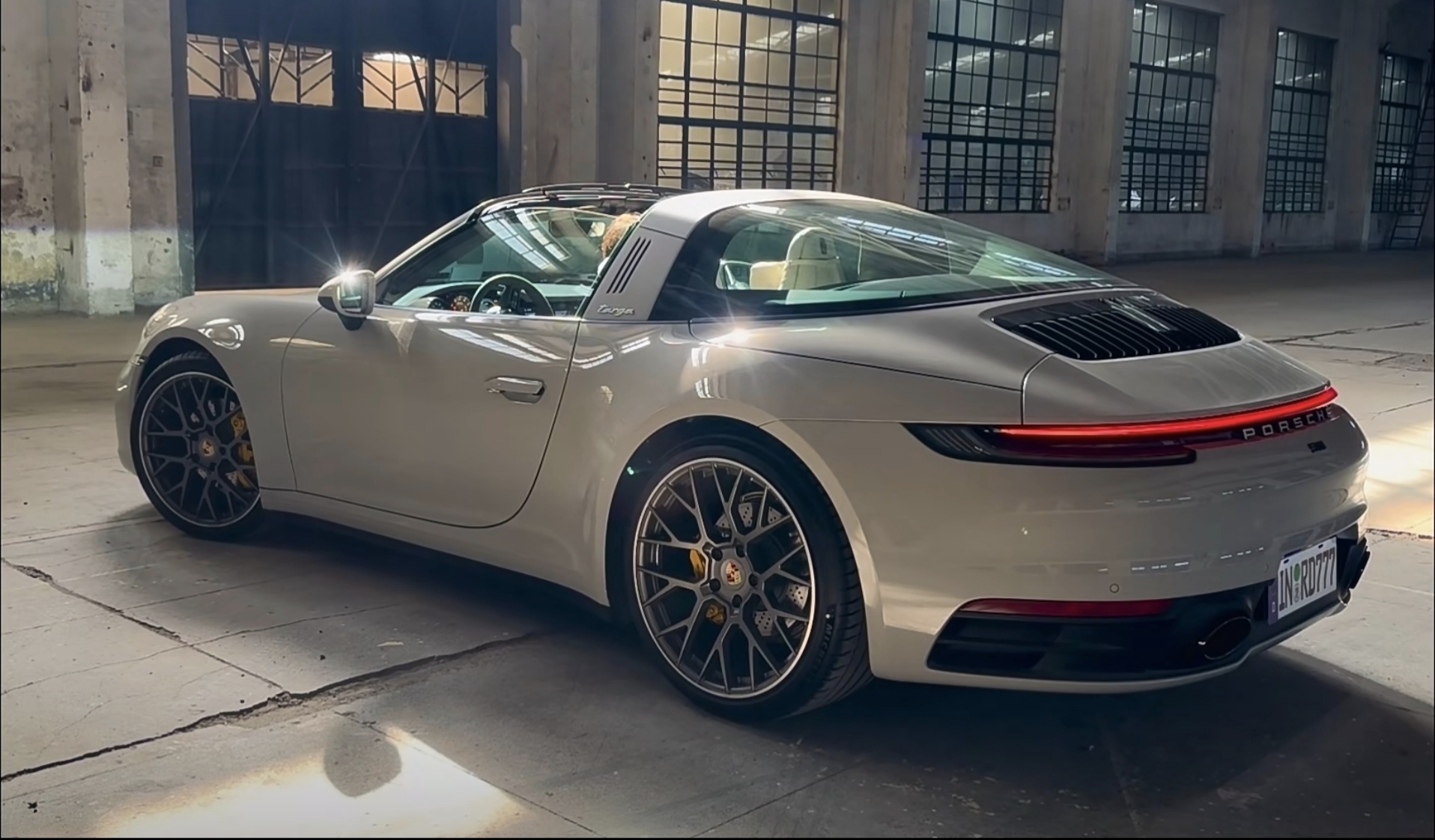 银色保时捷911 carrera targa,半透明的软顶设计,在阳光下显得格外