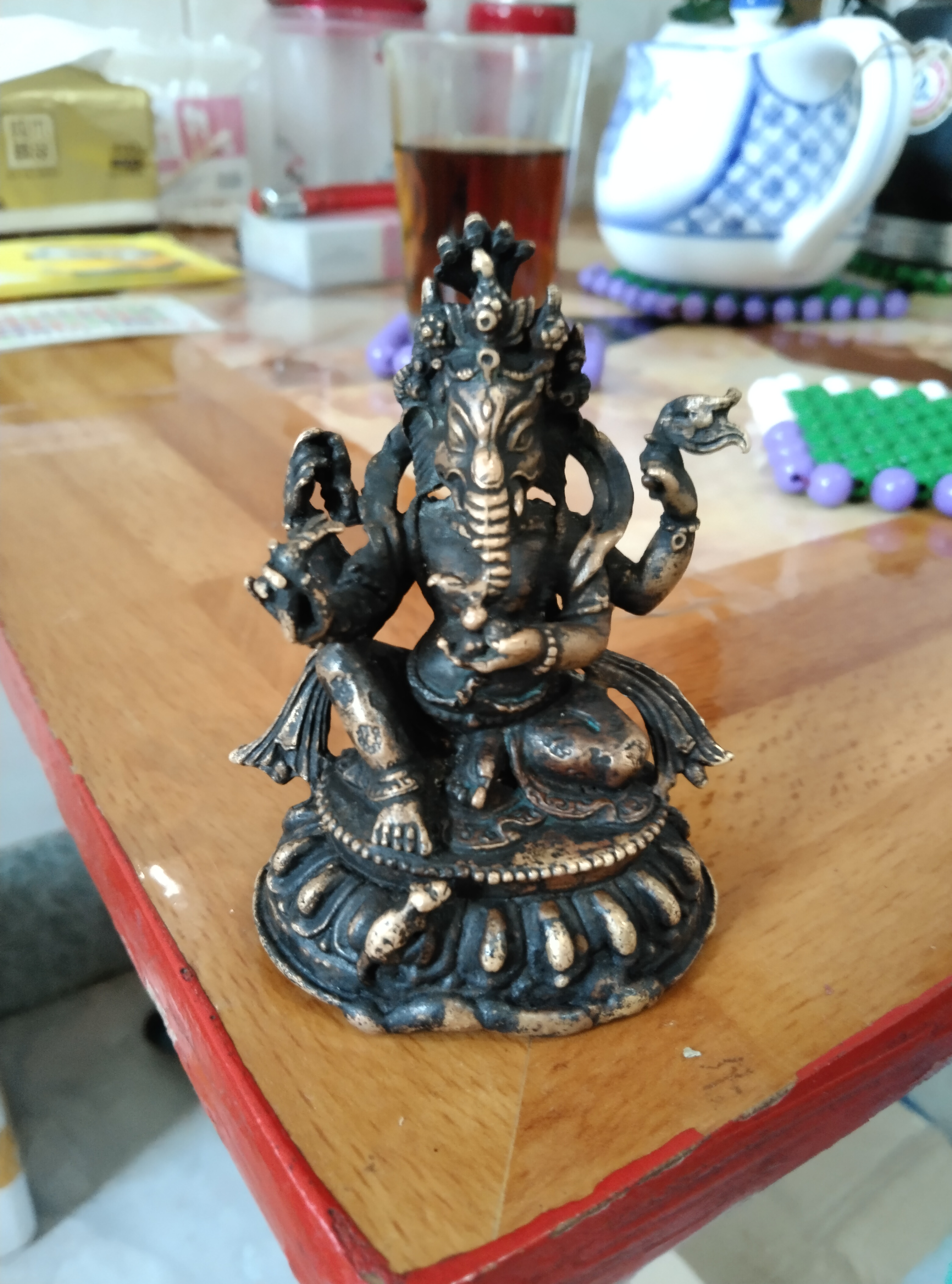 藏传四臂象神财神座像;材质:金铜,法相通体包浆黑漆古,内膛皮壳:朱砂