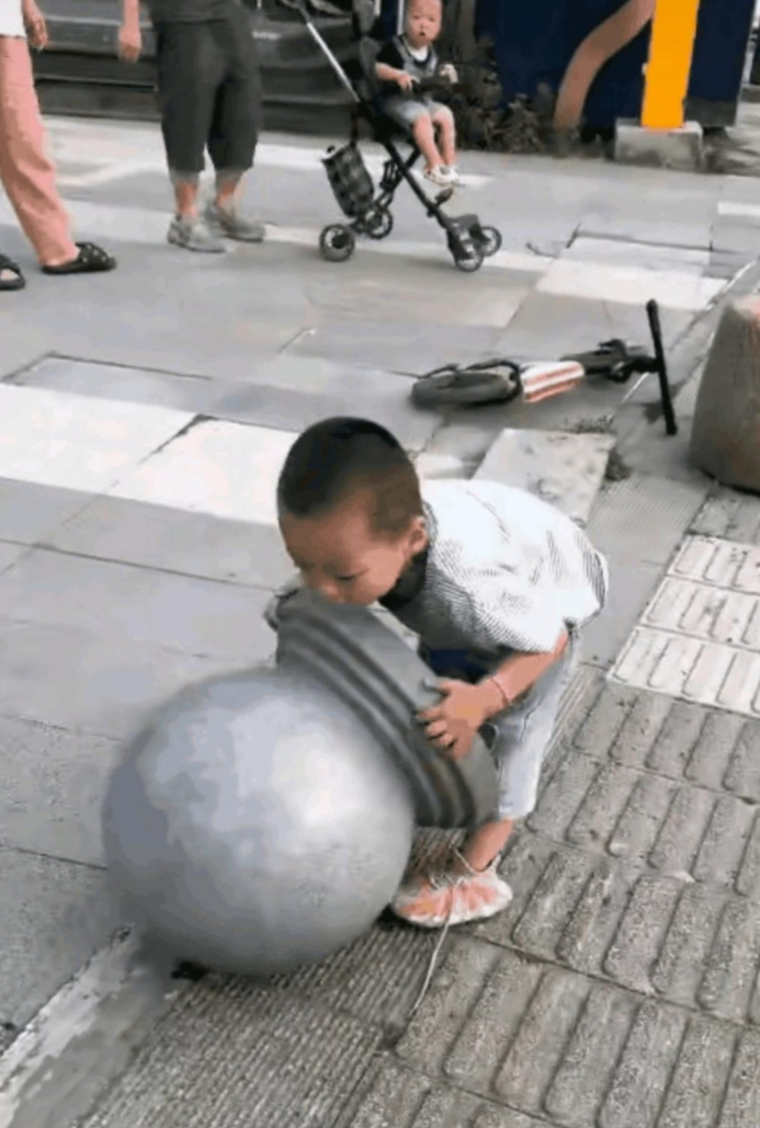 在小区门口小孩玩起了大力士,结果把石墩摔坏了.