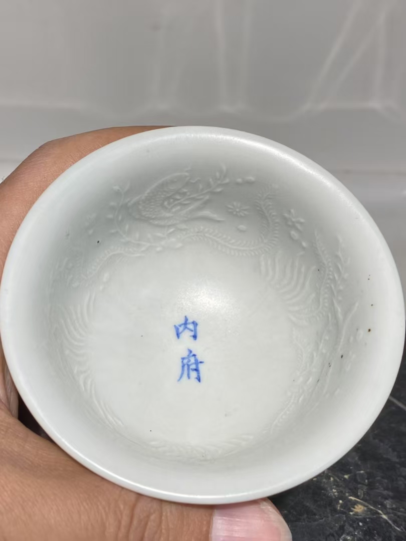 明代永乐甜白釉暗刻花卉鱼纹压手杯