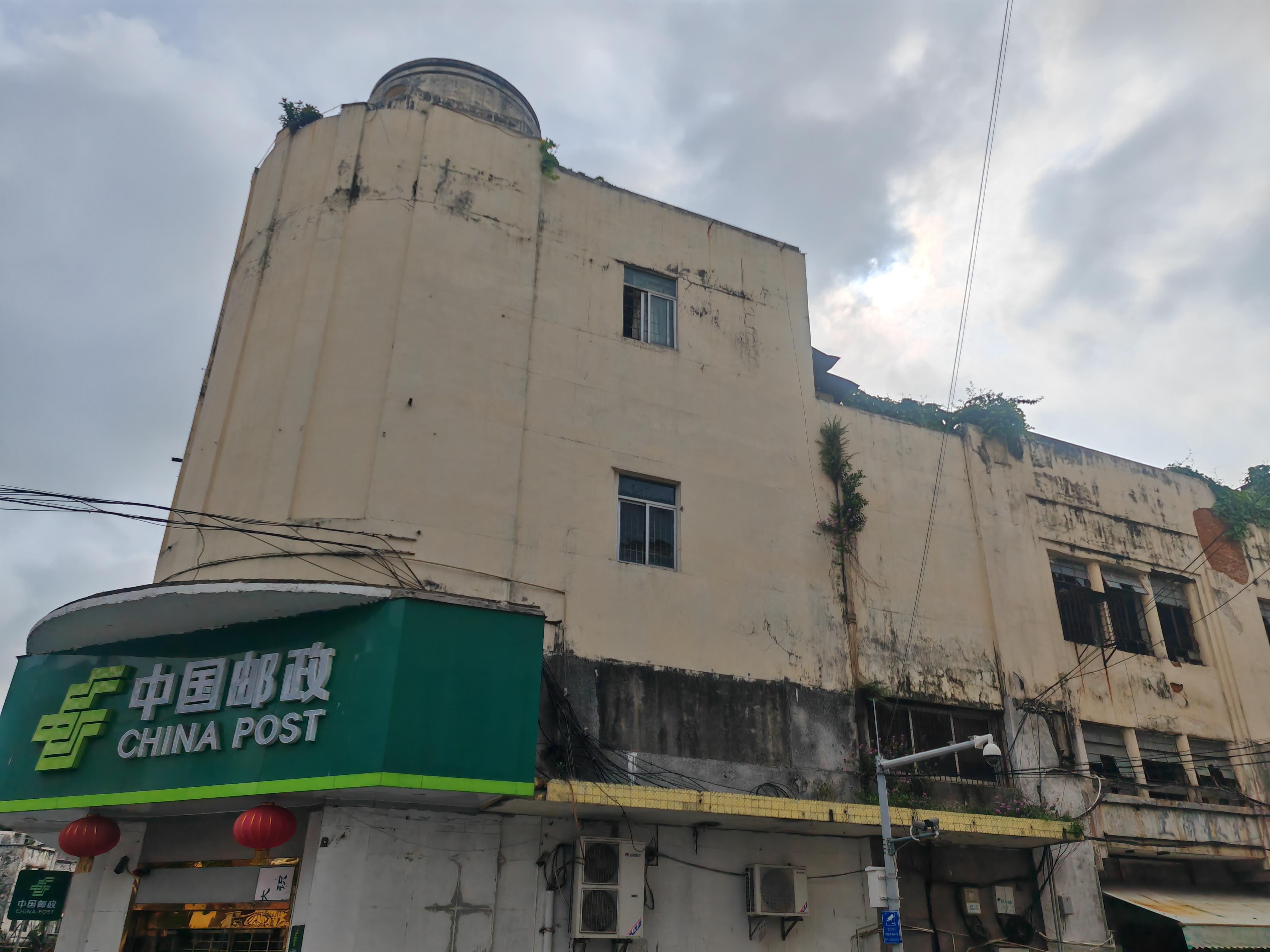 在广东湛江赤坎南华大酒店旧址旁边,有一幢历史建筑,上面挂着墨绿色的