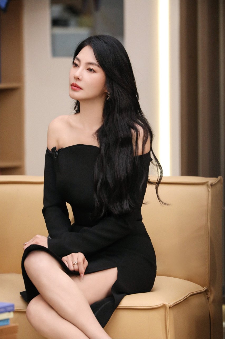 95  94张雨绮坐在沙发上身穿黑色露肩毛衣和灰色格子长裙,95