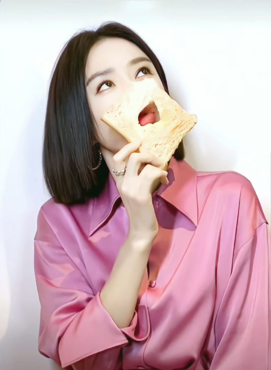 秦岚身着粉色衬衣边吃面包边摆拍,彰显出俏皮可爱的氛围感,而她的双眸