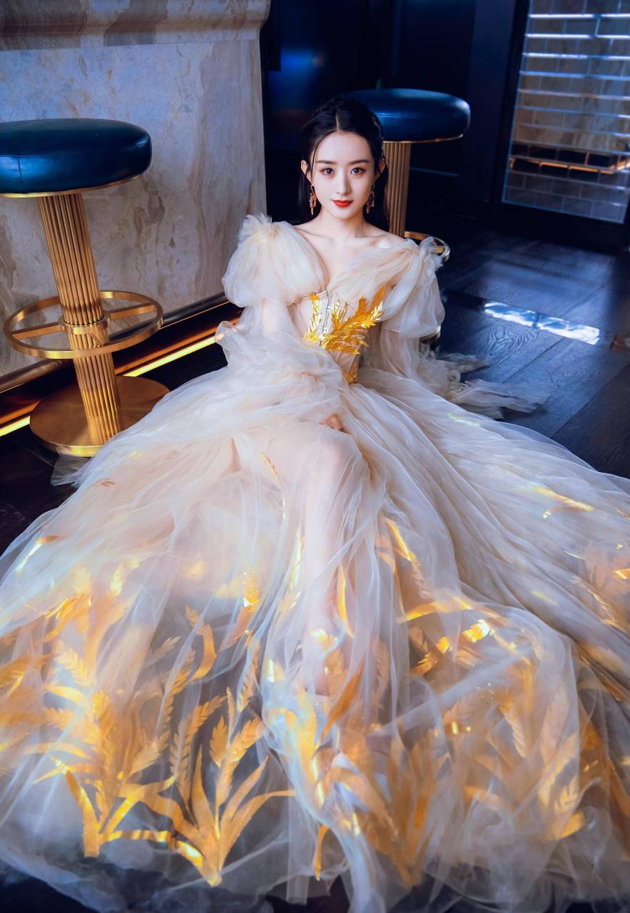 "优雅如画,赵丽颖身穿白色长裙,黑发披肩,头戴金色发卡,坐在地上,宛如