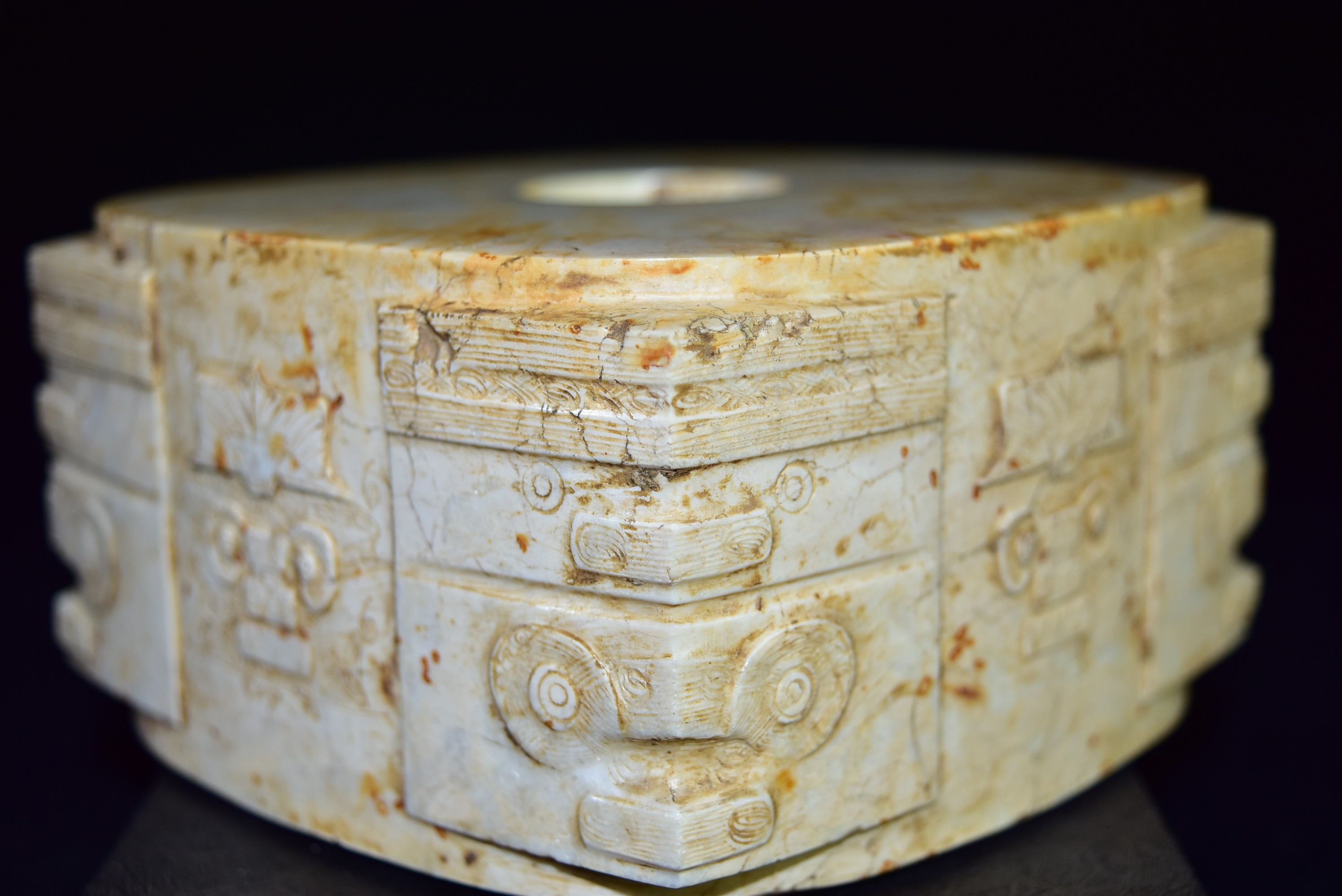 这是一枚良渚文化时期的神人纹饰玉琮,外方内圆暗合古人"天圆地方"的