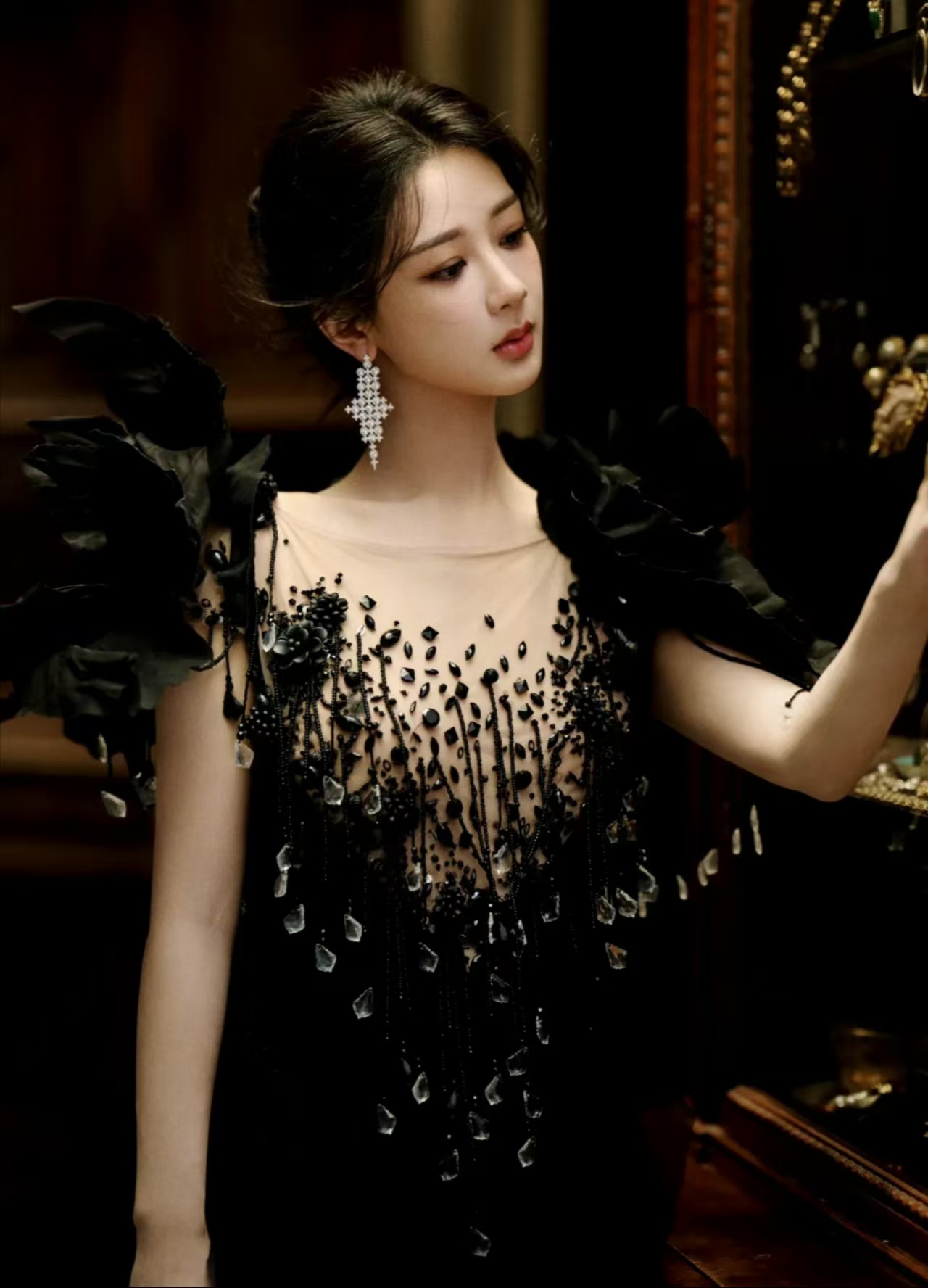 杨紫身穿黑色礼服,神秘而优雅,肩上的羽毛装饰如同夜空中闪亮的星辰