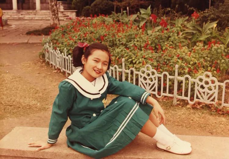 照片里她扎着双马尾,笑得像朵小太阳花