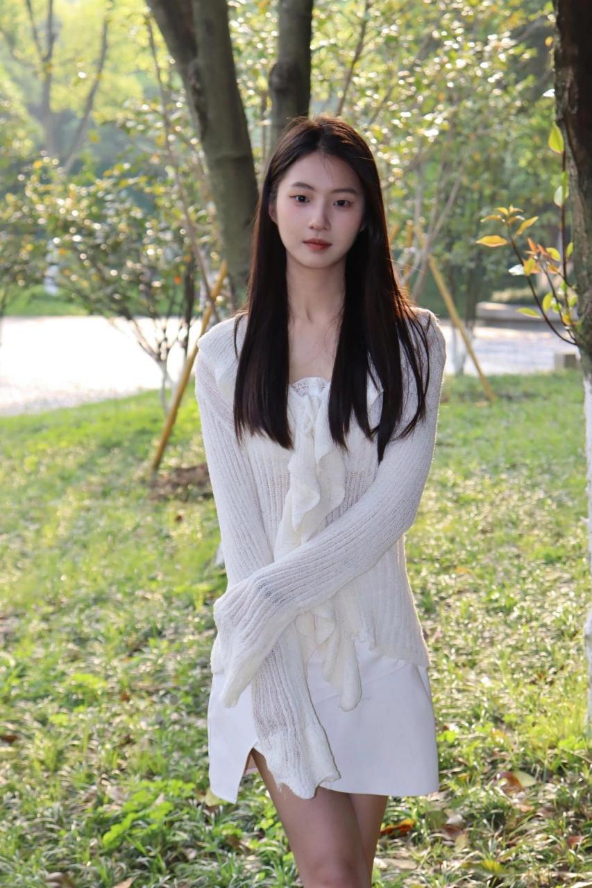 今天在阳光下,长发白裙美女静坐,笑容灿烂如花.