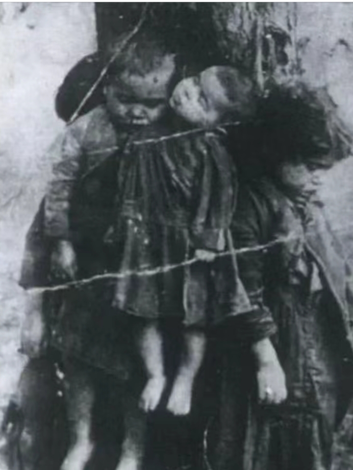 被日本鬼子用铁丝绑在树杆上吊死.看照片上有七,八个小孩