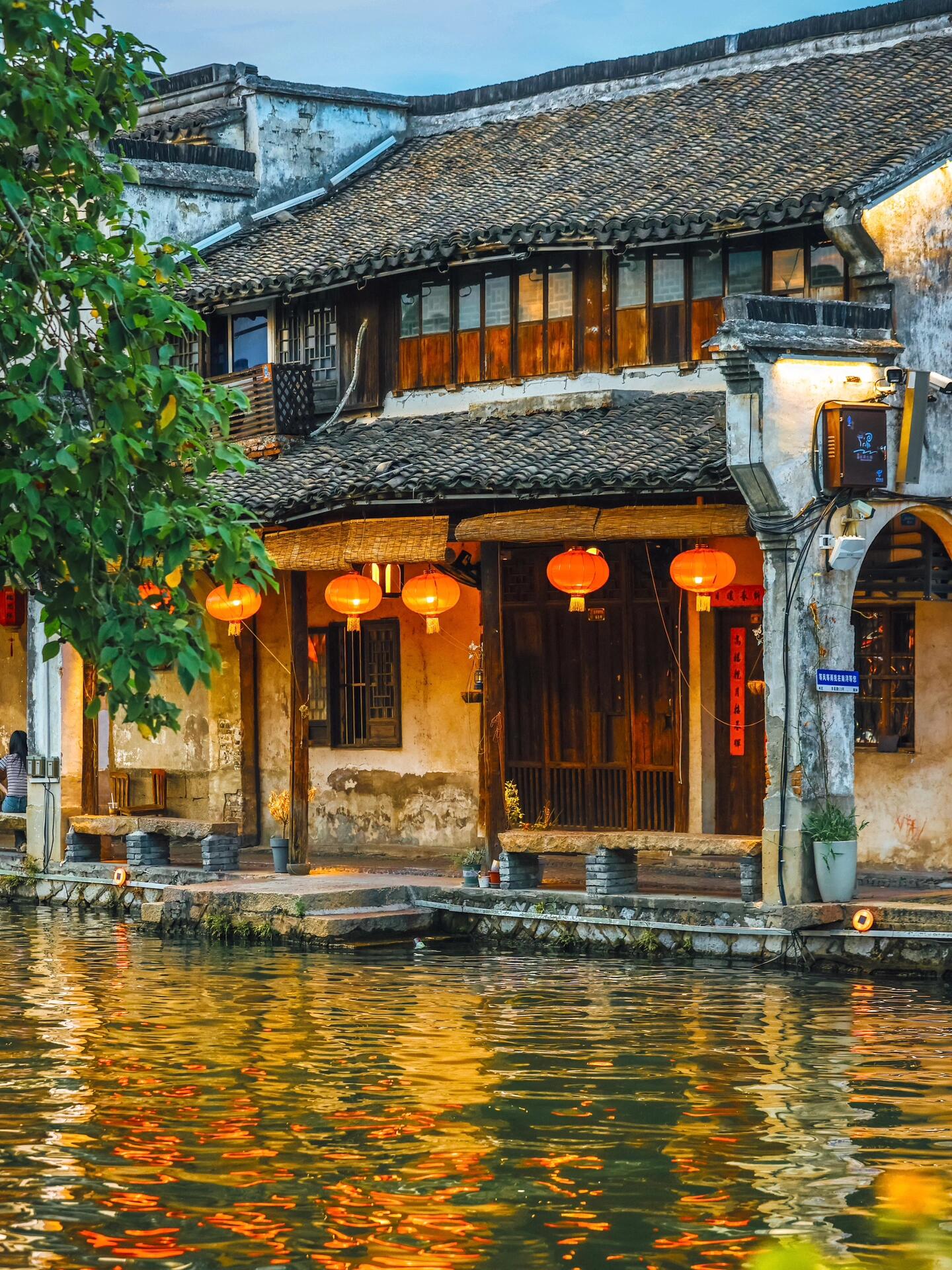哇,这河边的古风建筑群太美了吧,灯笼映着水波,仿佛穿越了时光.