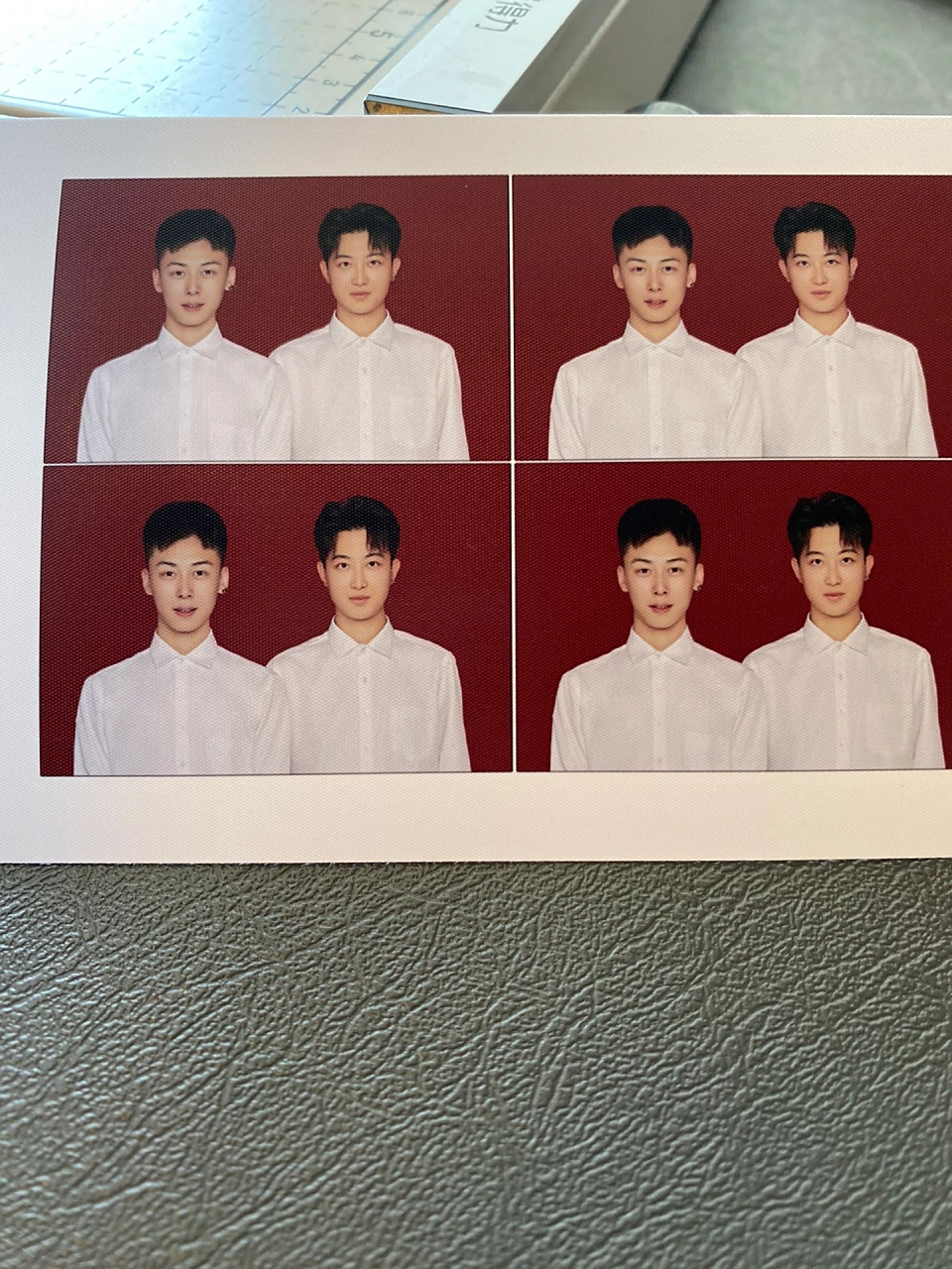 两个男生穿着白衬衫,拍红底证件照,有什么用途[并不简单]