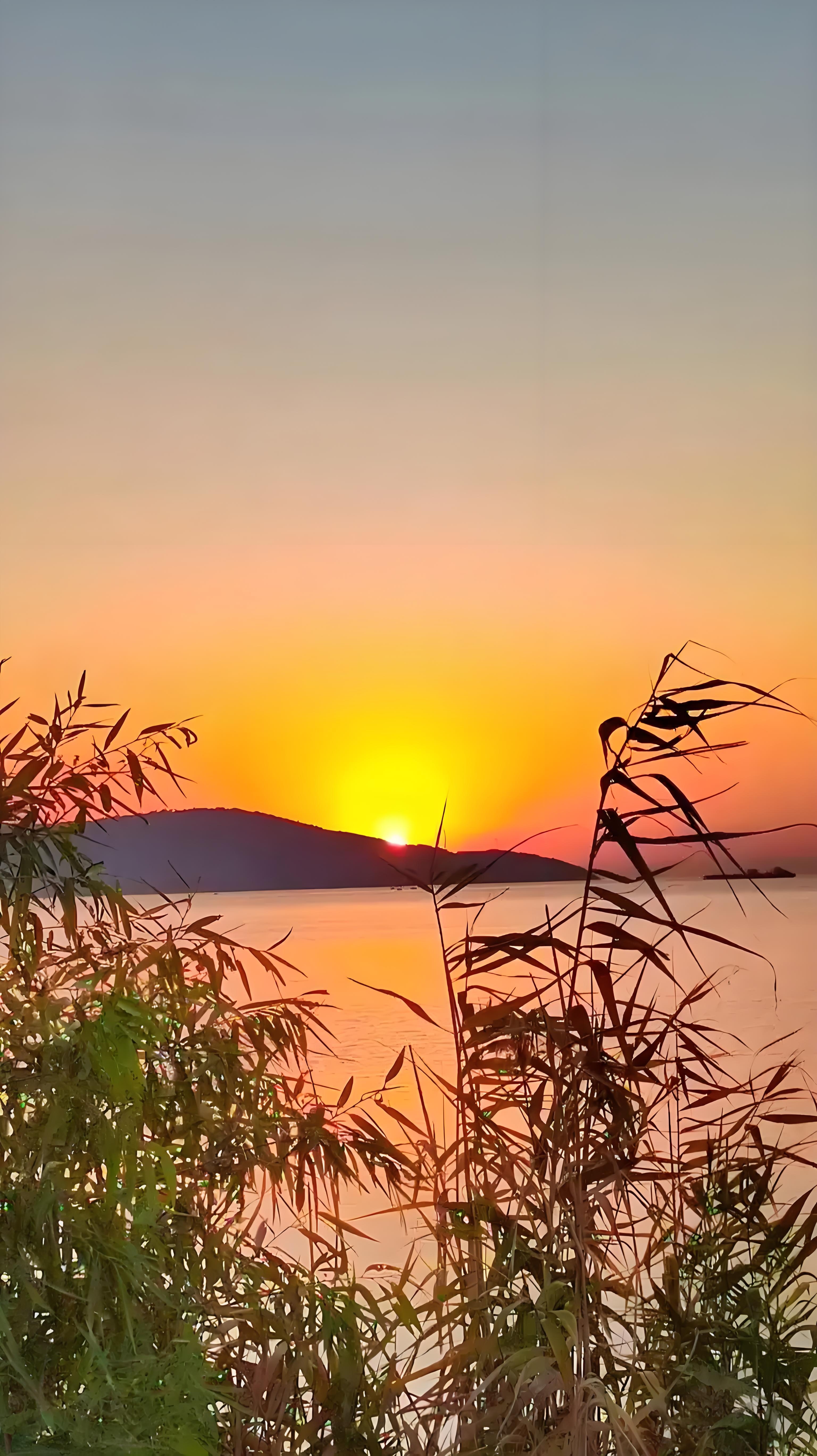 下联描绘了夕阳西下,余晖洒在西山之上的画面